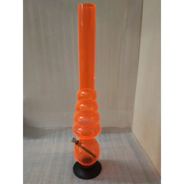 An upright orange acrylic waterpipe bong with a circular design and a black base.