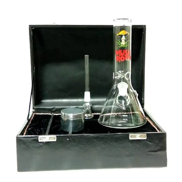 Moksha glass ice bong with mushroom print, along with a metal herb storage grinder, displayed in a black box.