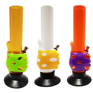 This image features three vibrant and colorful 12" acrylic water bongs from the Moksha Thumbs Up series. Each bong showcases a distinct and vivid color scheme, including one with a bright orange top and green base, another in white with yellow accents, and a third with a purple top and yellow base.