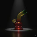 Glass smoking device with a gradient color on a dark background
6 Inch Rasta Glass Bong Online In India 