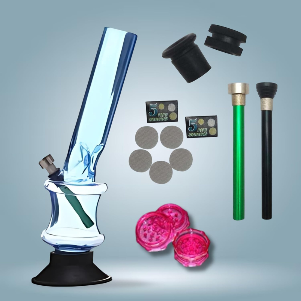 Glass bong with accessories on a gray background