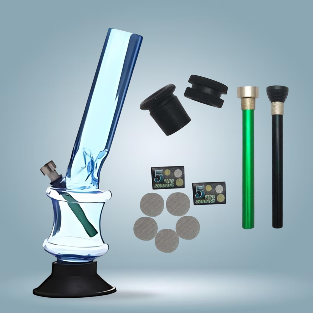 Glass bong with accessories on a gray background