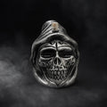 Skull-shaped object with a hood on a dark background