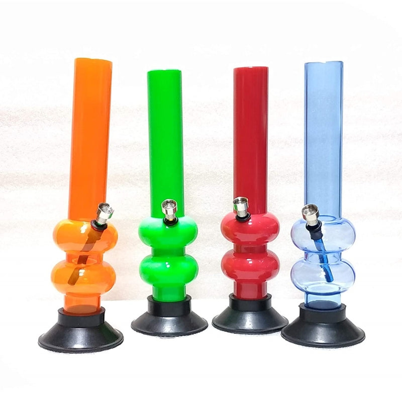 This image displays a collection of four Moksha 12-inch double bulb acrylic smoking water pipes, each featuring a vibrant, glossy finish. The water pipes come in an array of attractive colors: orange, green, red, and blue, each with a matching base that appears to be suction-mounted for stability.