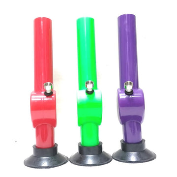 This image displays three Moksha 12-inch heart-shaped acrylic smoking water pipes, known as bongs, each presented in different colors: red, green, and purple. These bongs are crafted from acrylic, a material resembling glass but known for its durability, lightweight nature, and resistance to fragility.