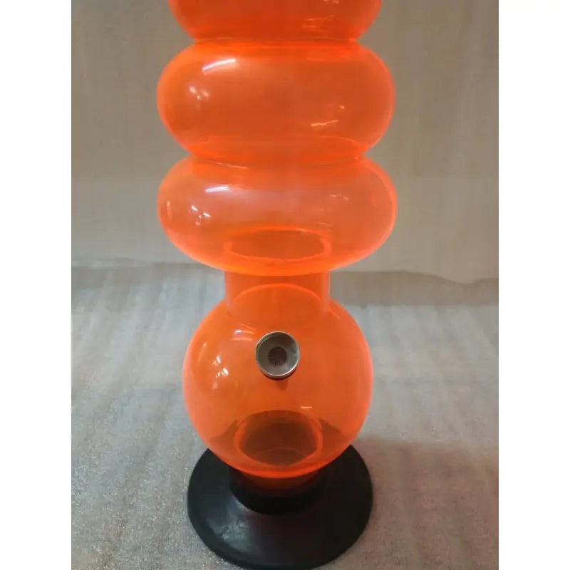 A 22 inch tall transparent orange acrylic waterpipe bong with multiple bulbous sections and a black base.