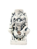 A ceramic water bong in the shape of a devil with a star on its head.