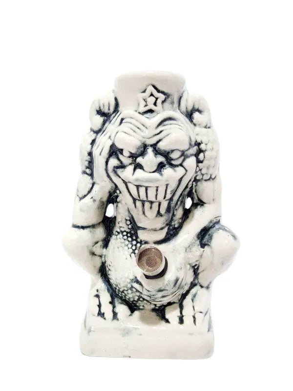 A ceramic water bong in the shape of a devil with a star on its head.