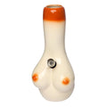 A ceramic water pipe with a female breast design, predominantly white with orange accents, and a rounded body.