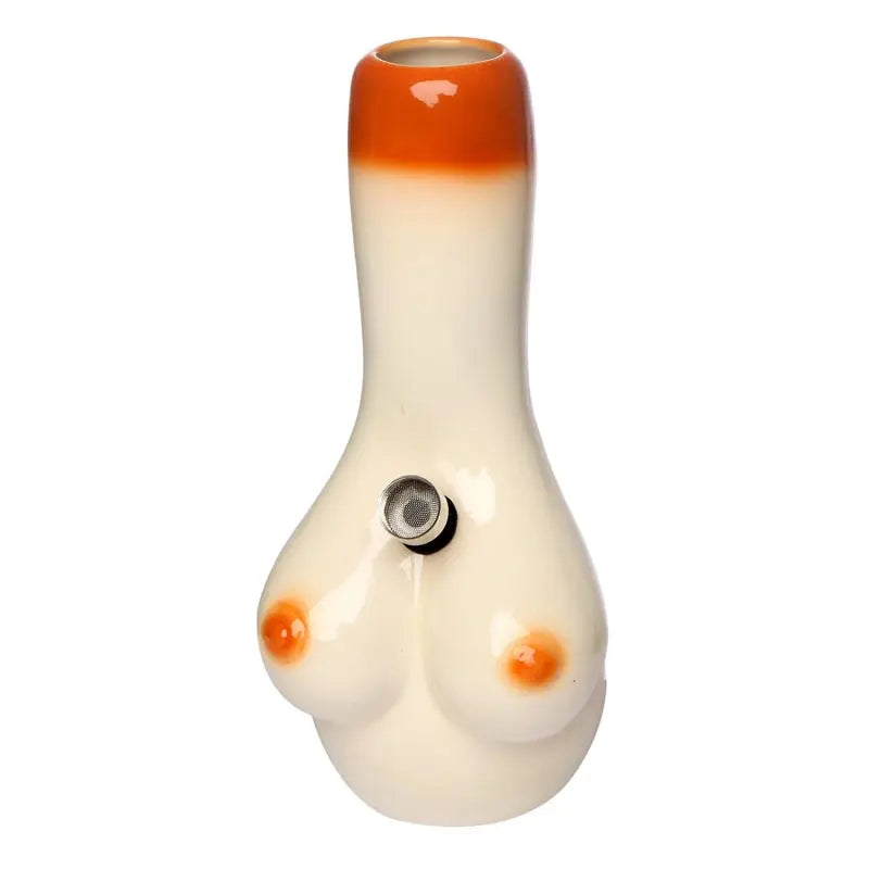 A ceramic water pipe with a female breast design, predominantly white with orange accents, and a rounded body.